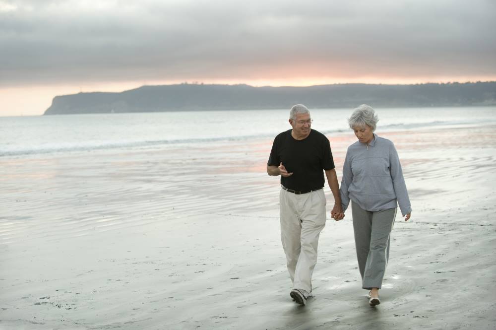 seniors-holding-hands-beach